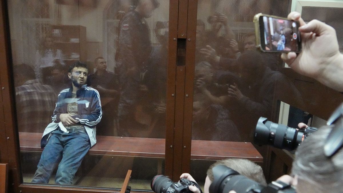 Four bruised and bloodied men charged over Moscow concert attack 