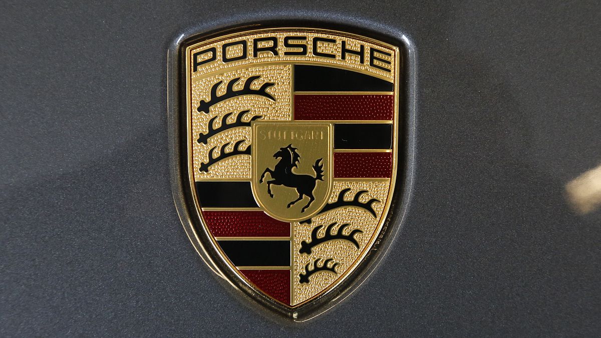 Porsche revs up for intro to new models but puts brake on profit hopes