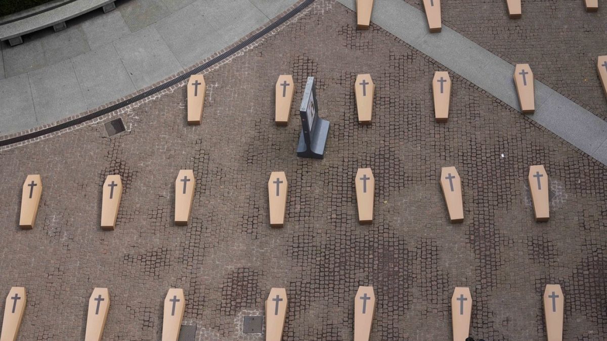 Protesters lay mock coffins in Milan over workplace safety in Italy 