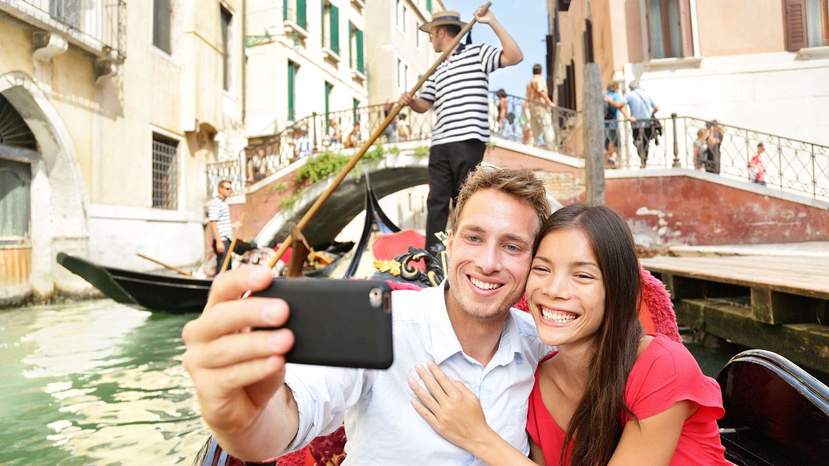 Selfies are more lethal than shark attacks. Should more tourist destinations ban them? 