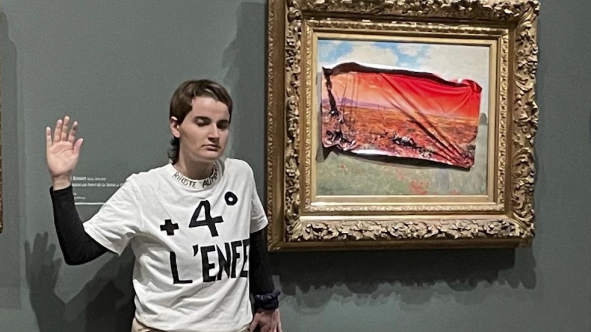 Climate protester sticks poster over Monet painting at the Musee D'Orsay  